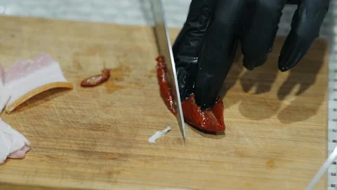 The cook's black-gloved hands are slicing the bitter pepper. A professional chef Stock Footage 132031815