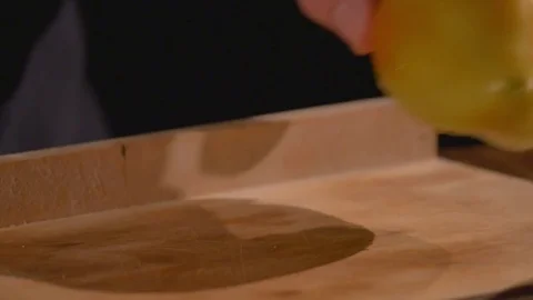A cook's hand cuts a bell pepper by a knife on a cutting board Stock Footage 84603840