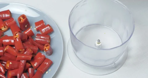 Cook's Hand Puts Chopped Hot Red Pepper From A Plate In A Flask For A Blender Stock Footage 128096311