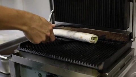 Cook's hand taking off a kebab from grill Stock Footage 73459074
