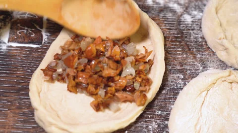 Cook's hands are preparing a pie with mushrooms and onion Stock Footage 254167818