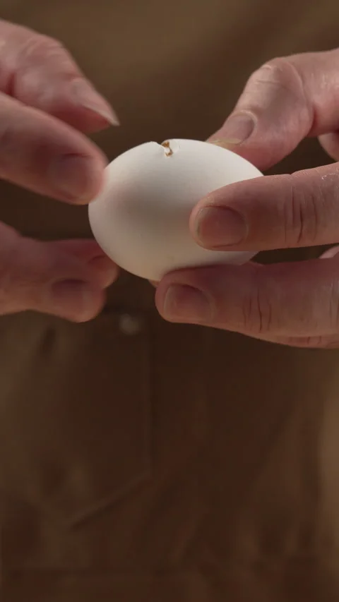 Cooks hands break the egg with knife for baking. Stock Footage 343254138