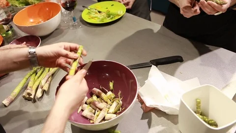 Cook's hands clean, cutting and prepare asparagus for a dish Stock Footage 113016584