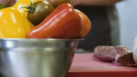 Cook's hands cutting into a large piece of raw meat using a butcher's knife Stock Footage 78734026