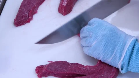 Cook's hands cutting red beef steaks with a butcher knife 4 Stock-Footage 245216670