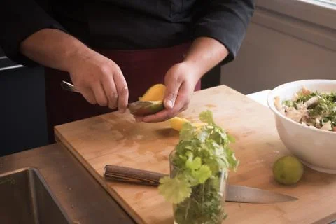 Cook's hands emptying a mango Stock Photos