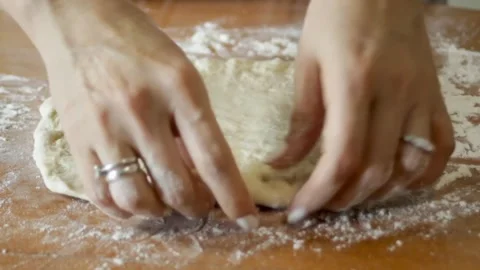 The cooks hands gently pull the edges of the dough, forming a circle. Preparing Stock Footage 315028702