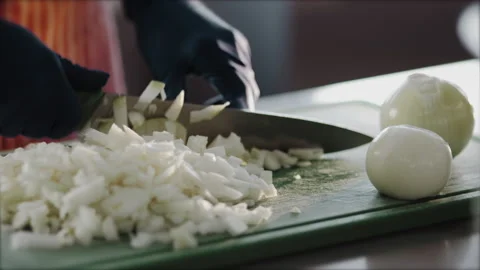 The cook's hands in gloves cut onions in the kitchen. food concept Stock Footage 149147584