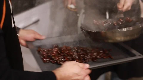 Cook's hands hold bakery tray with almonds in sugar Stock-Footage 113016381