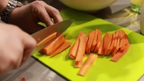 Cook's hands preparing carrots on cutting board Stock Footage 113016425