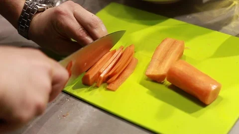 Cook's hands preparing carrots on cutting board Stock Footage 115286015