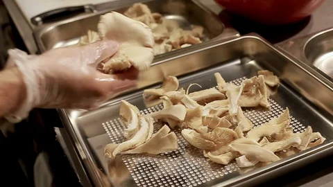Cook's hands preparing mushrooms on baking tray Stock Footage 111072211