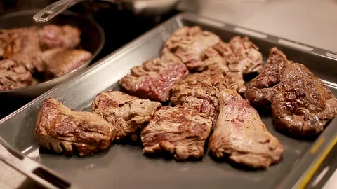 Cook's hands preparing roasted meat on baking tray Stock Footage 111072239