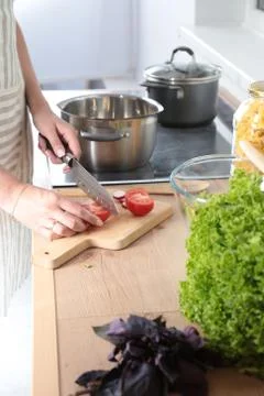 Cook's hands preparing vegetable salad - closeup shot Stock Photos