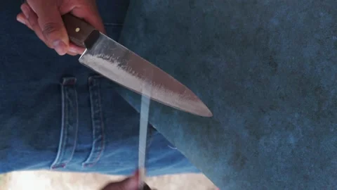 Cook's hands sharpening two knives. Cooking concept. Stock Footage 220735564