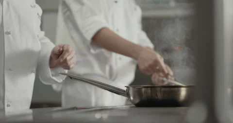 Cooks in the kitchen preparing food Stock Footage 254882017
