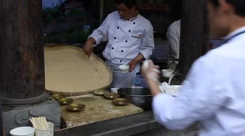 Cooks making Sandapao, so called triple bangs, a famous traditional street food Stock Footage 48917491