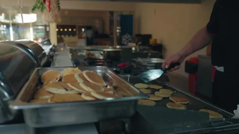 Cooks making small and big pancake for morning breakfast in hotel kitchen, sweet Stock Footage 279055981