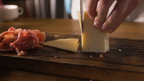 Cook's work in a modern restaurant. Professional slicing cheese for the Stock Footage 88991205