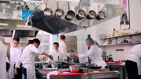 The cooks working on the kitchen in the restaurant Stock Footage