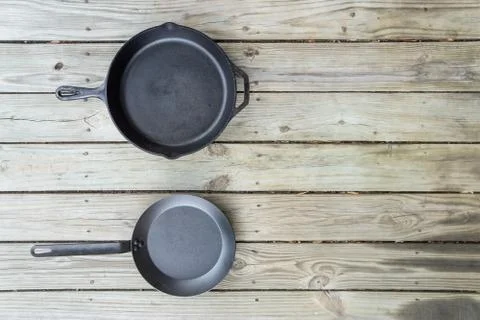 Cookware battle with cast iron vs teflon vs carbon steel cooking options Stock Photos