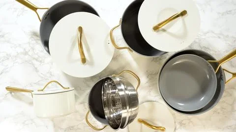 Cookware with steamer insert arranged on counter Stock Photos