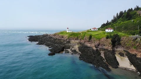 Cool aerial of a lighthouse and rip tides at Cape D'or Nova Scotia Canada Stock Footage 116706256