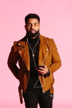 Cool African American man with beard, listening music, looking at camera, iso Stock Photos
