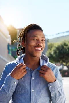 Cool african guy with dreadlocks smiling outside Stock Photos