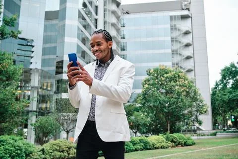 Cool african man using the mobile outdoors Stock Photos