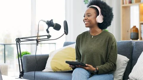 Cool afro journalist using digital tablet, talking into microphone and hosting Stock Photos