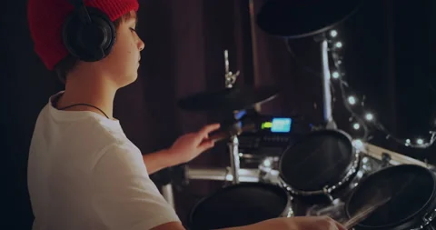 Cool and talented young boy playing drums in white tshirt performing song in Stock-Footage 140474953