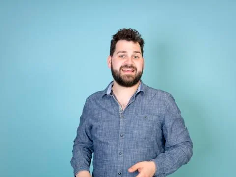 Cool and young man posing in front of blue background with copy space Foto stock
