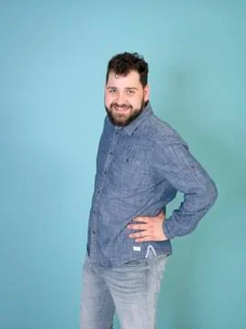 Cool and young man posing in front of blue background with copy space Stock Photos