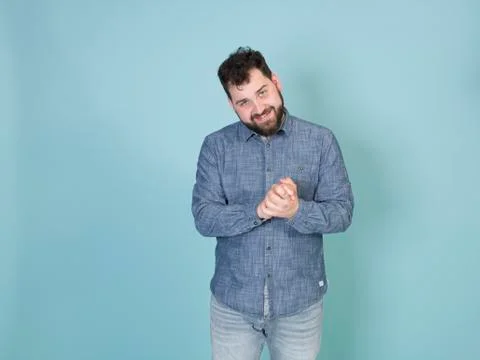 Cool and young man posing in front of blue background with copy space Foto stock