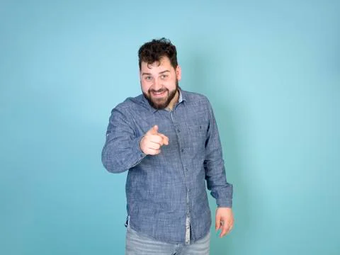 Cool and young man posing in front of blue background with copy space Stock Photos