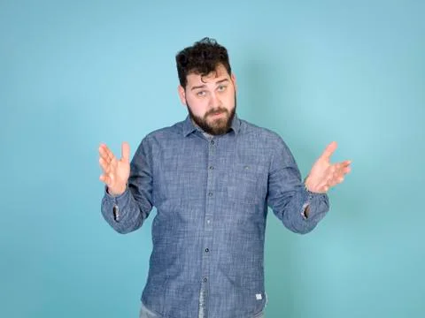 Cool and young man posing in front of blue background with copy space Foto stock