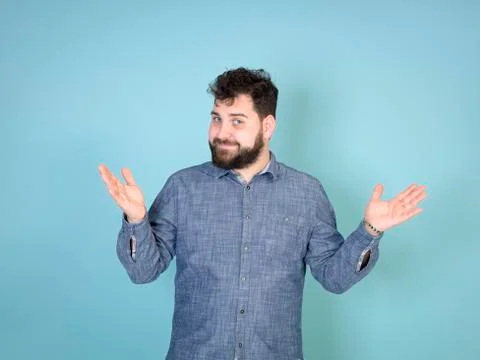 Cool and young man posing in front of blue background with copy space Stock Photos