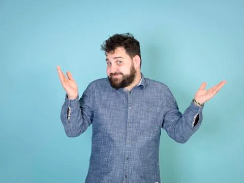 Cool and young man posing in front of blue background with copy space Foto stock