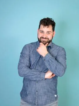 Cool and young man posing in front of blue background with copy space Stock Photos