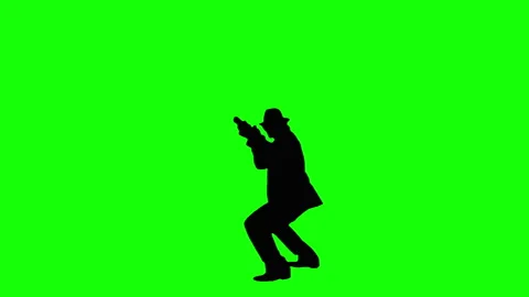 Cool armed young man in a suit with a rifle on a green background. Stock Footage 131436732