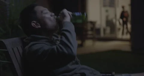 Cool Asian MAn drinking Beer interrupted by his Kid 2 Stock Footage 196849527