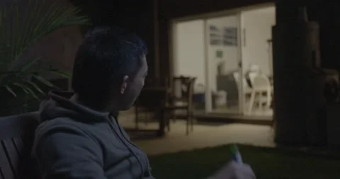 Cool Asian Man drinking Beer interrupted by KId Stock Footage 196849531