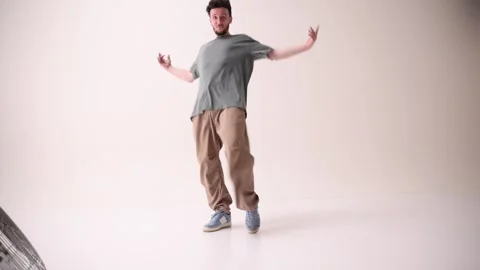 Cool attitude young man, talented freestyle dancer dancing in motion against Video stock 303347938