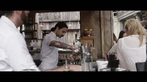 Cool bartender mixing drink for customer side view Vidéo 56979218