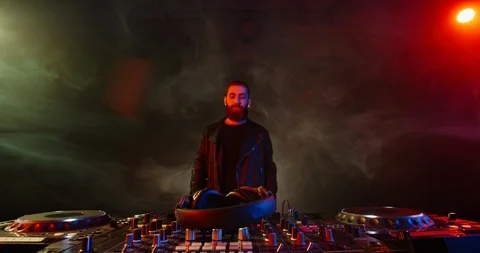 A cool bearded dj approaching the mixer controller, ready to compose a new mix Stock Footage 127138724