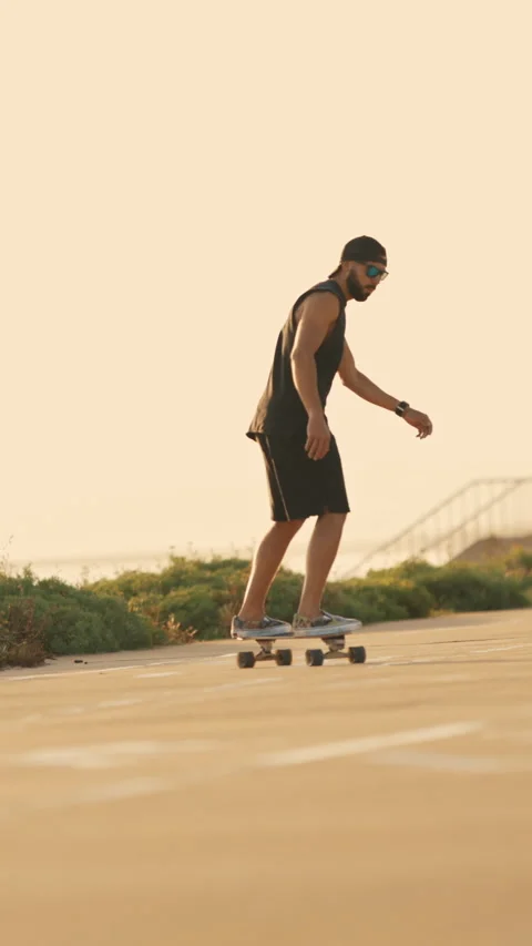 Cool bearded guy skating on skateboard on the street Stock Footage 328578716