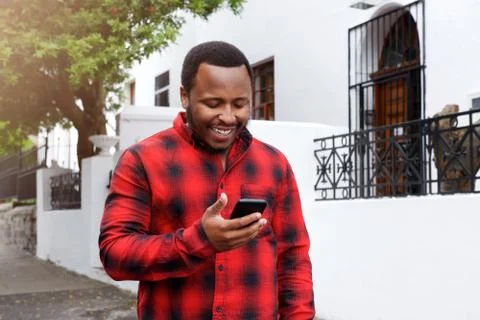 Cool black guy smiling outside with cell phone Stock Photos