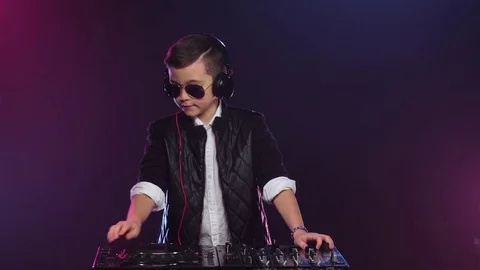 Cool boy dj with glasses playing on vinyl. Slow motion Stock Footage 75916032