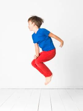 Cool boy is jumping in front of white background Stock Photos